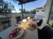 Backyard hibachi dinner table with warm lamps and string lights ready for an evening at-home chef event