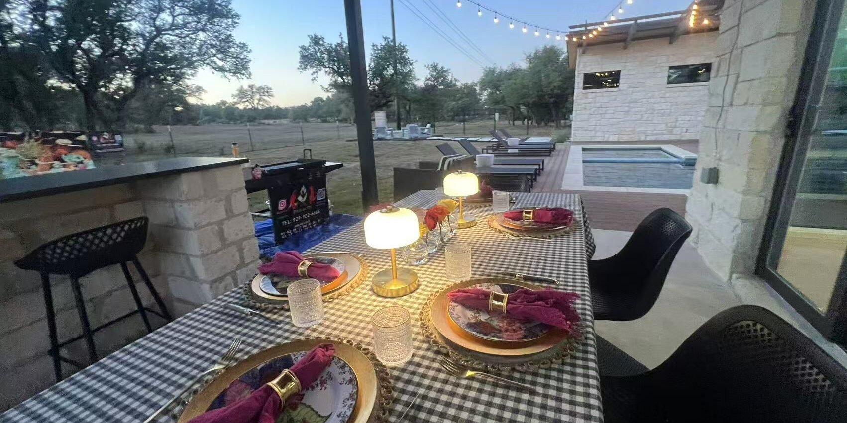 Backyard hibachi dinner table with warm lamps and string lights ready for an evening at-home chef event