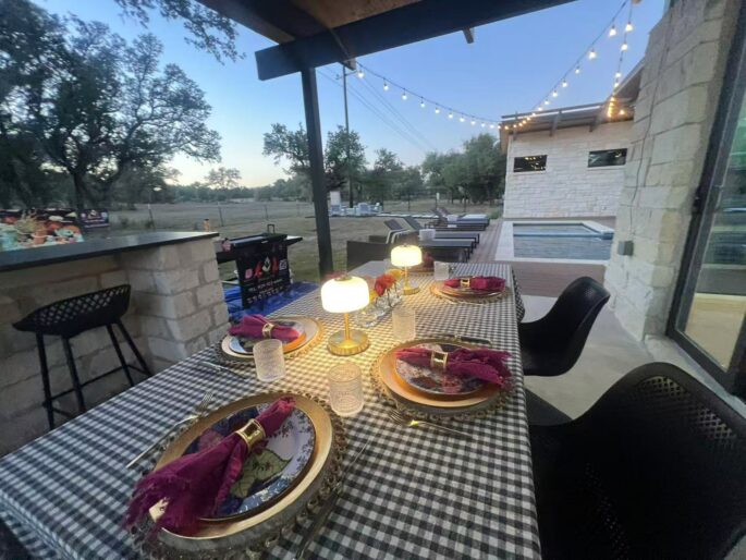 Backyard hibachi dinner table with warm lamps and string lights ready for an evening at-home chef event