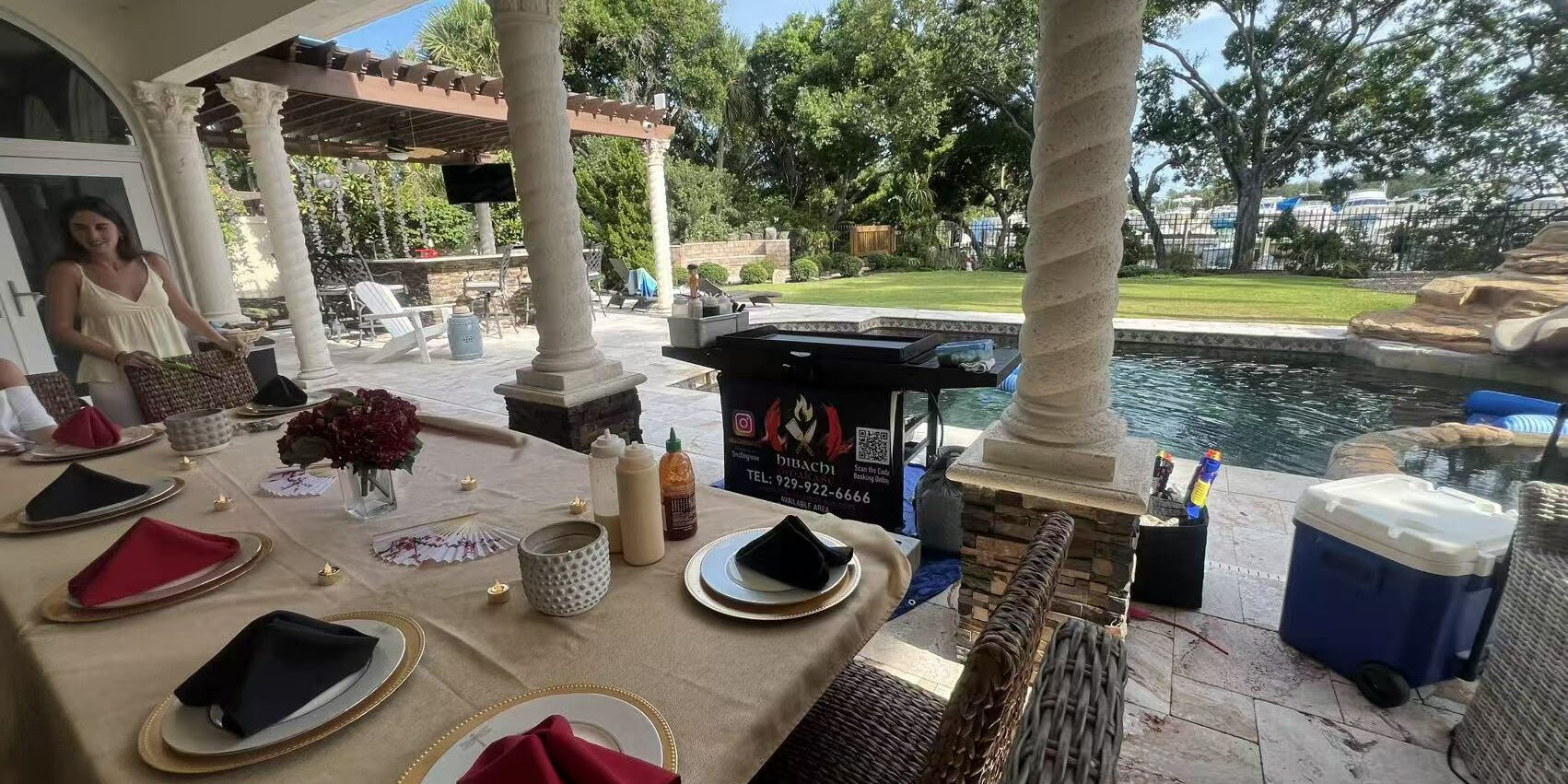 Covered patio hibachi at home setup with dining table and grill ready for a backyard rain backup plan