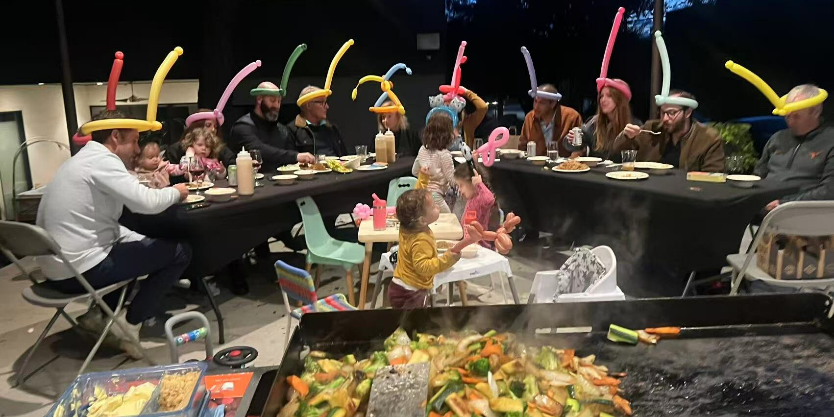 Hibachi at home allergy questions checklist for a backyard dinner with vegetables cooking on the grill and guests seated nearby Hibachi at home allergy questions checklist for a backyard dinner with vegetables cooking on the grill and guests seated nearby
