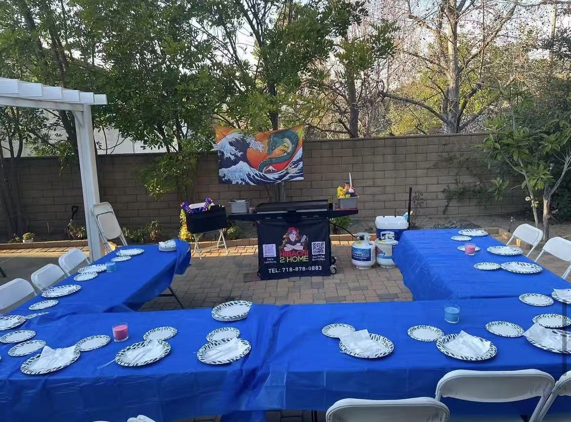 Private hibachi chef cooking on a portable grill at a US backyard patio dinner