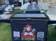 Hibachi 2 Home branded portable grill set up on a backyard lawn beside long guest tables for an evening hibachi party at home